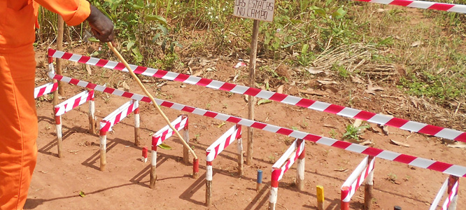 MgM uses different colours at the tops of the wooden stakes, since delineating safe and unsafe areas, and marking different classification of mines and scrap. 